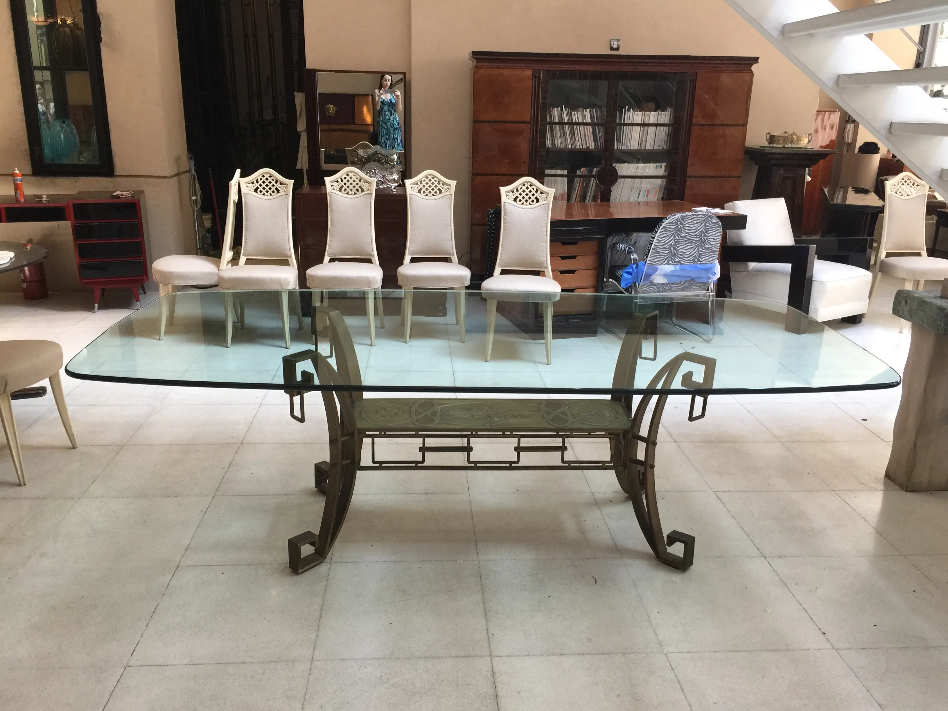 Antique dining table in Art Deco style seating 10, set in a stylish environment.