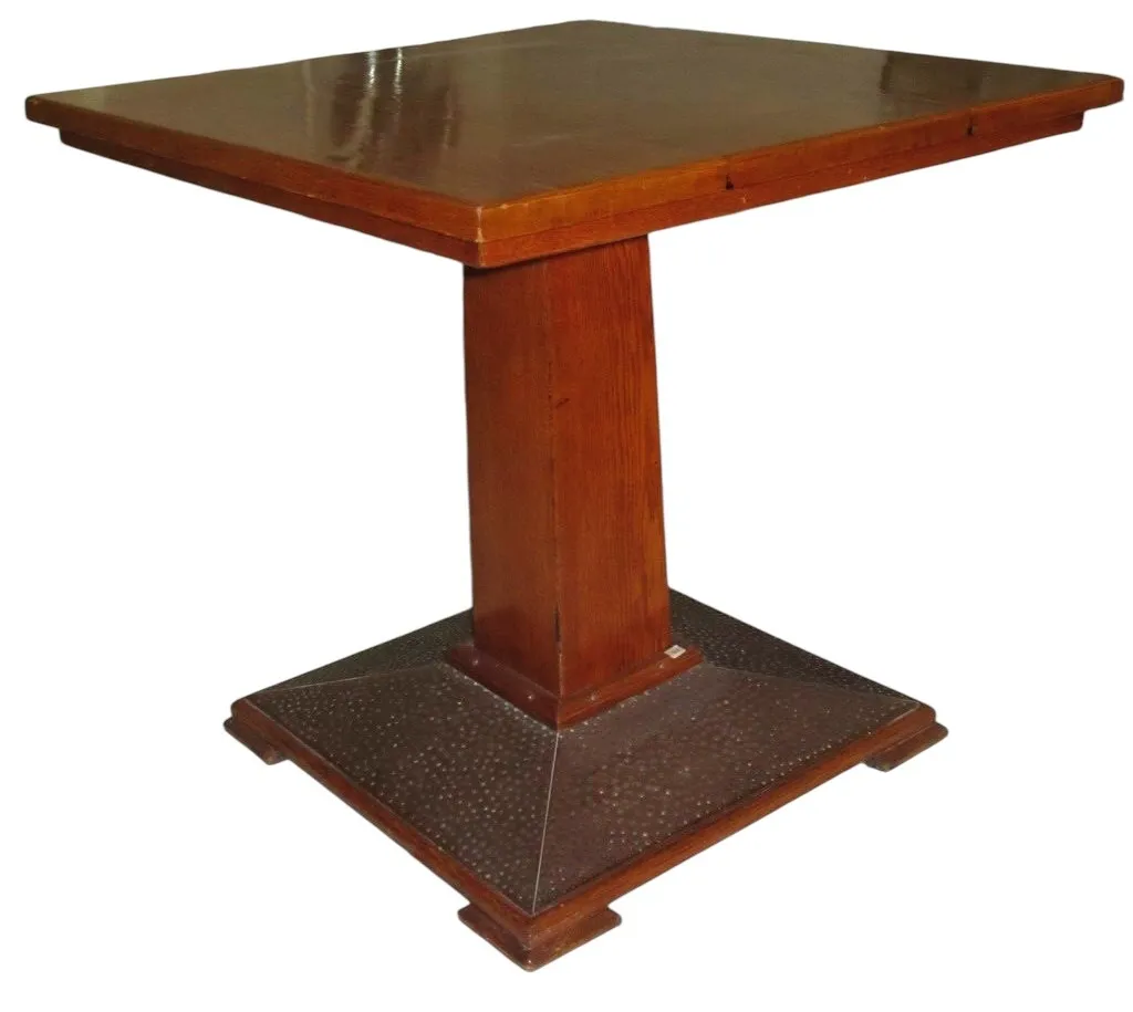 Antique dining table with square top and pedestal, suitable for 4 people in a cozy setting.