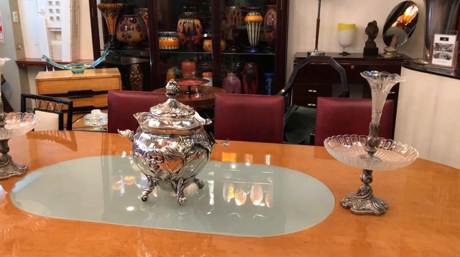 Antique WMF punch bowl with decorative details, on a modern table.