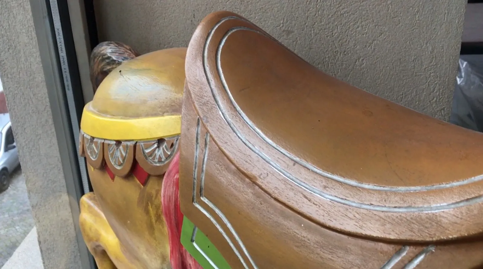 An antique llama decoration featuring colorful, curved details.