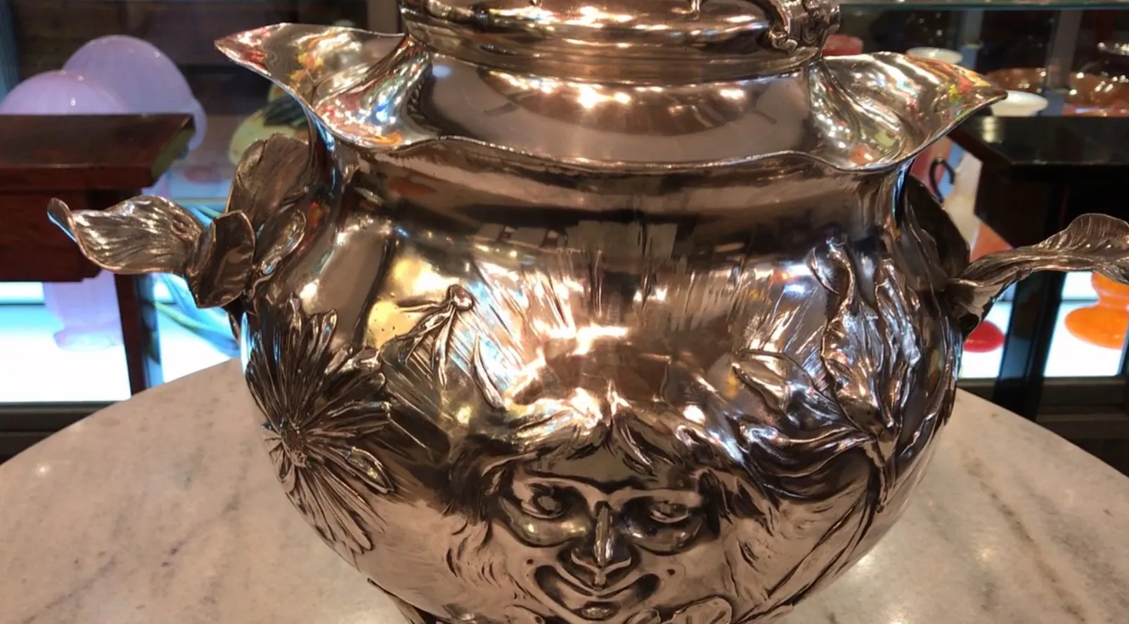 Beauty of WMF punch bowl with floral and face details, shiny and antique.