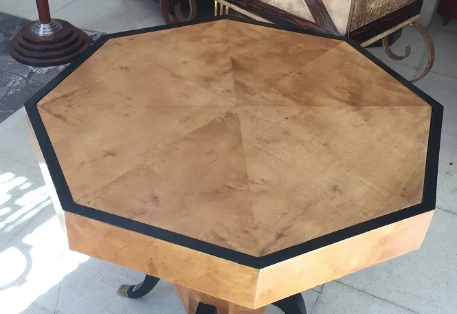 Antique octagonal table with Art Deco design, elegant setting.