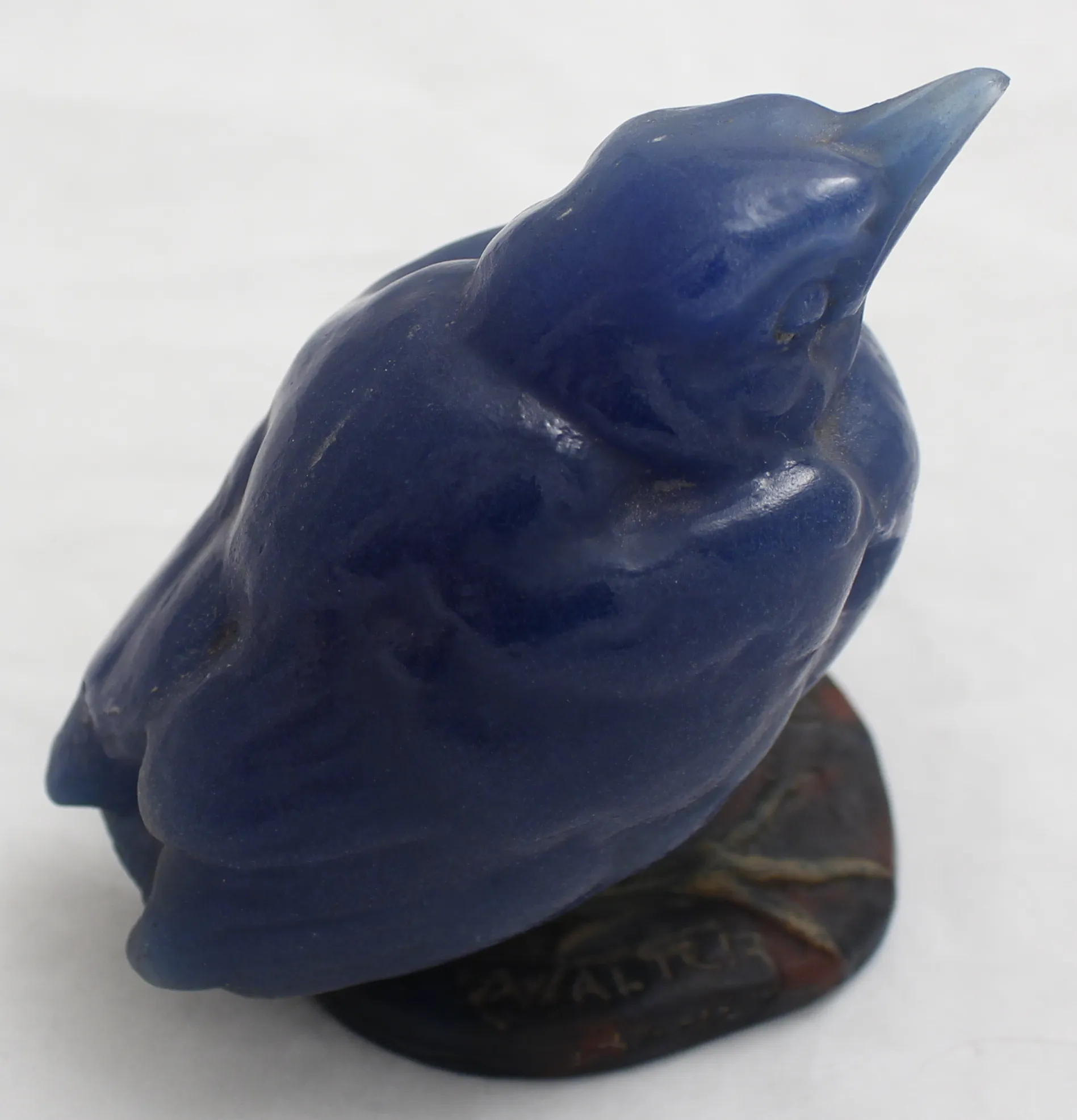 Blue glass bird figure with a signature, antique style.