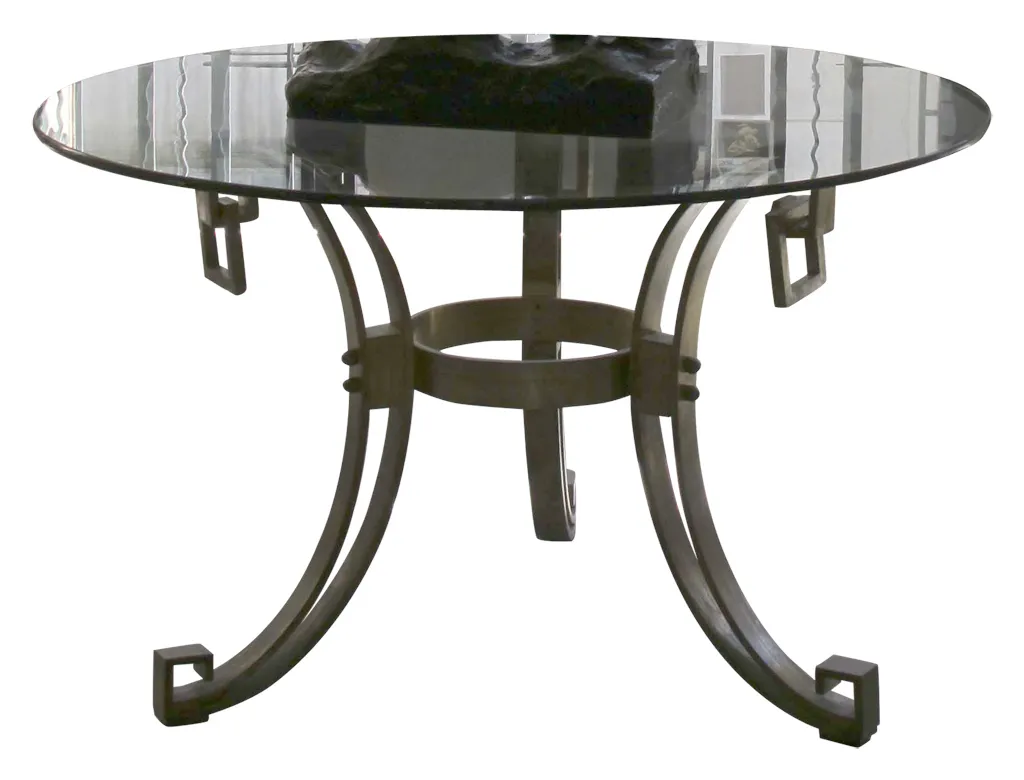 antique art deco round dining table for 4 people, featuring a black object in the center.