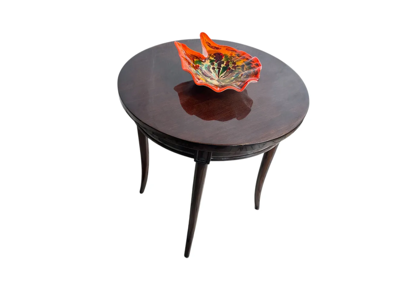 Antique round table with a decorative bowl on top