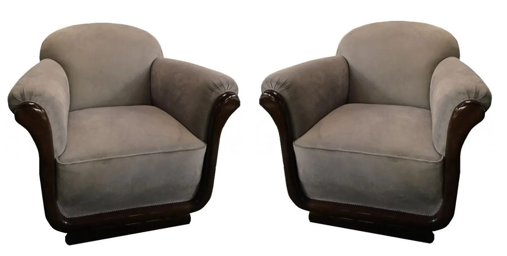 Two antique armchairs with a cozy design in an elegant setting.
