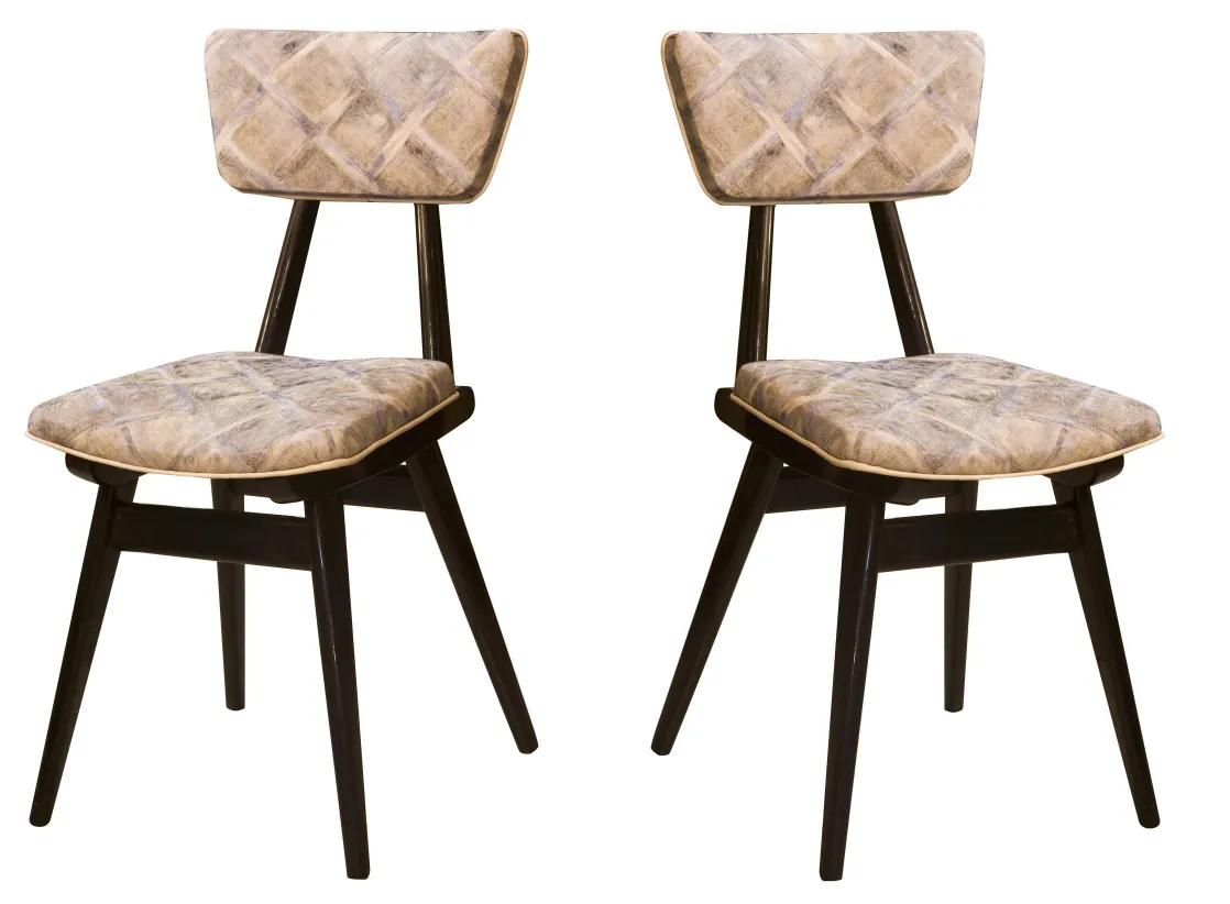 Two antique chairs with neutral colors and an attractive design in a cozy setting.