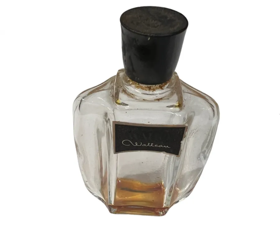 Antique perfume bottle with a black cap, elegant design, clear glass with golden liquid