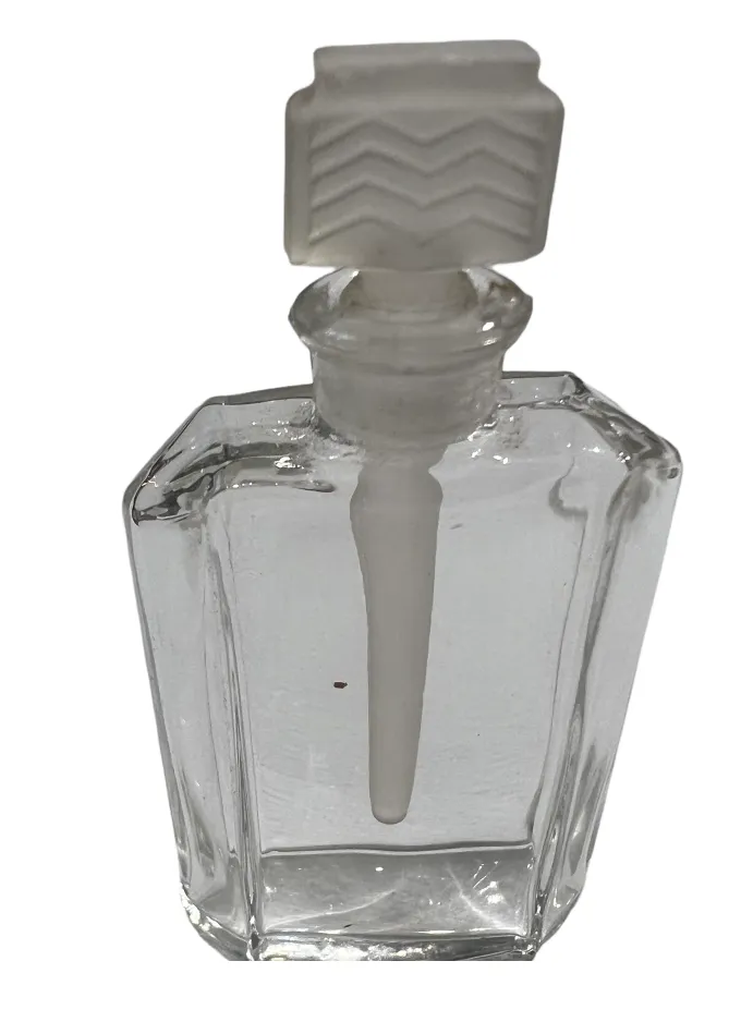 antique glass perfume bottle with white applicator
