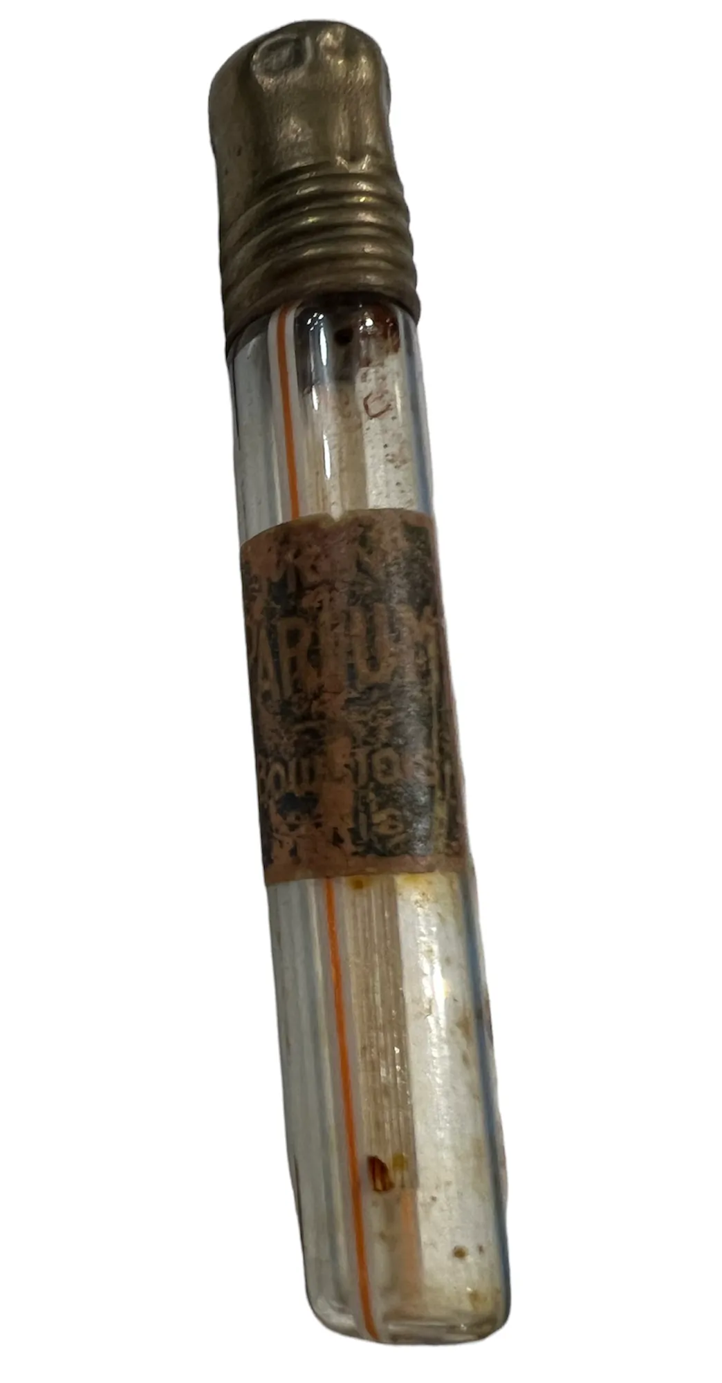 Antique perfume bottle with a golden cap and worn label