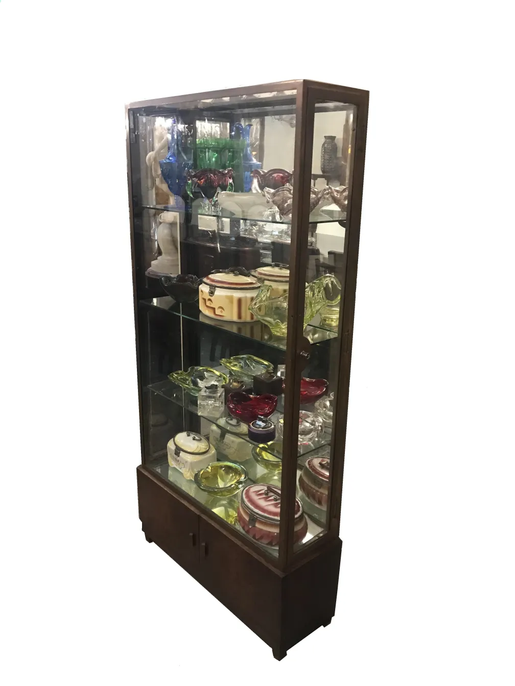 antique display cabinet with shelves showcasing various decor