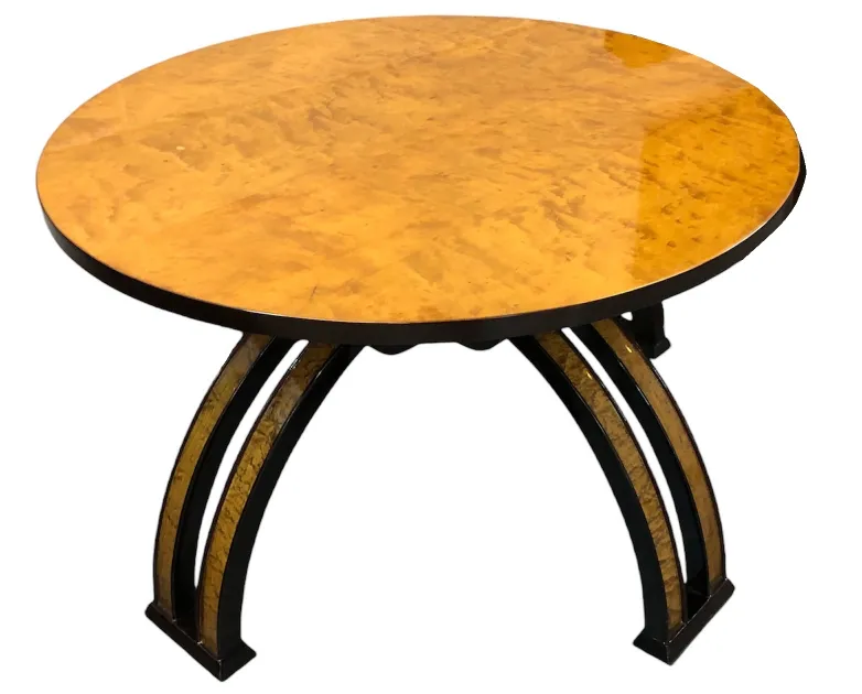 antique round coffee table with elegant design and curved legs in a cozy setting