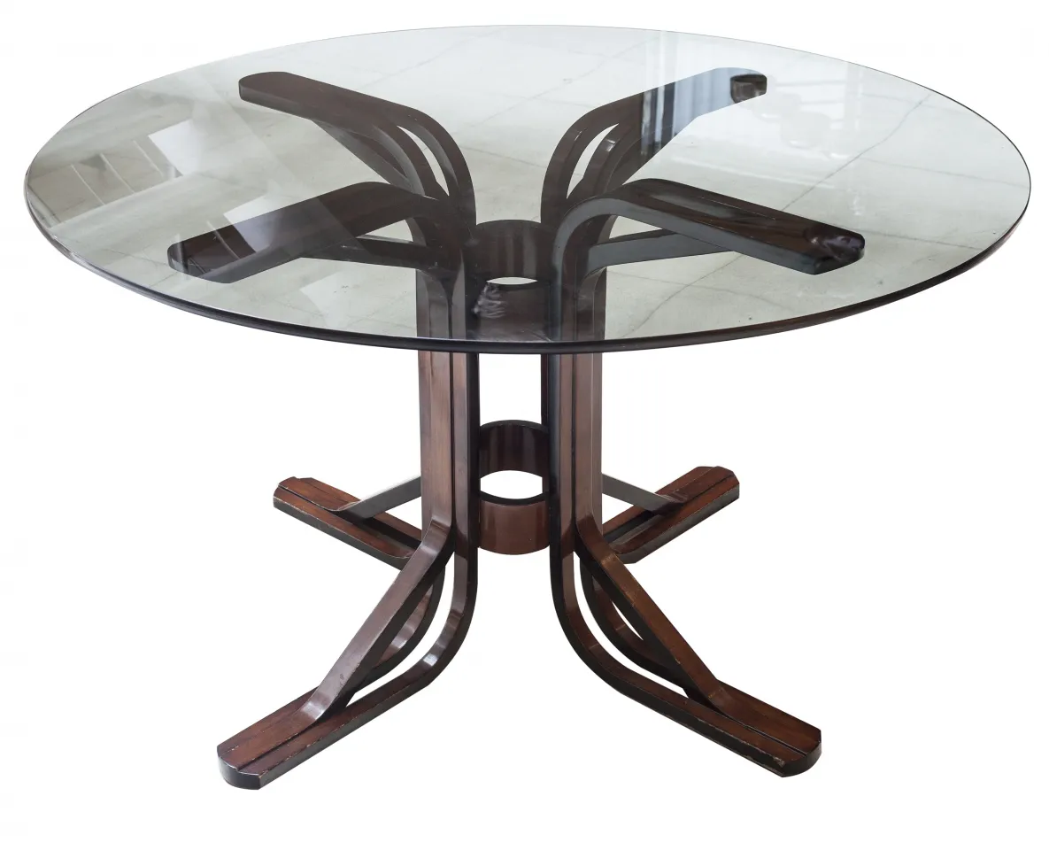 Round antique dining table for six people in a bright setting