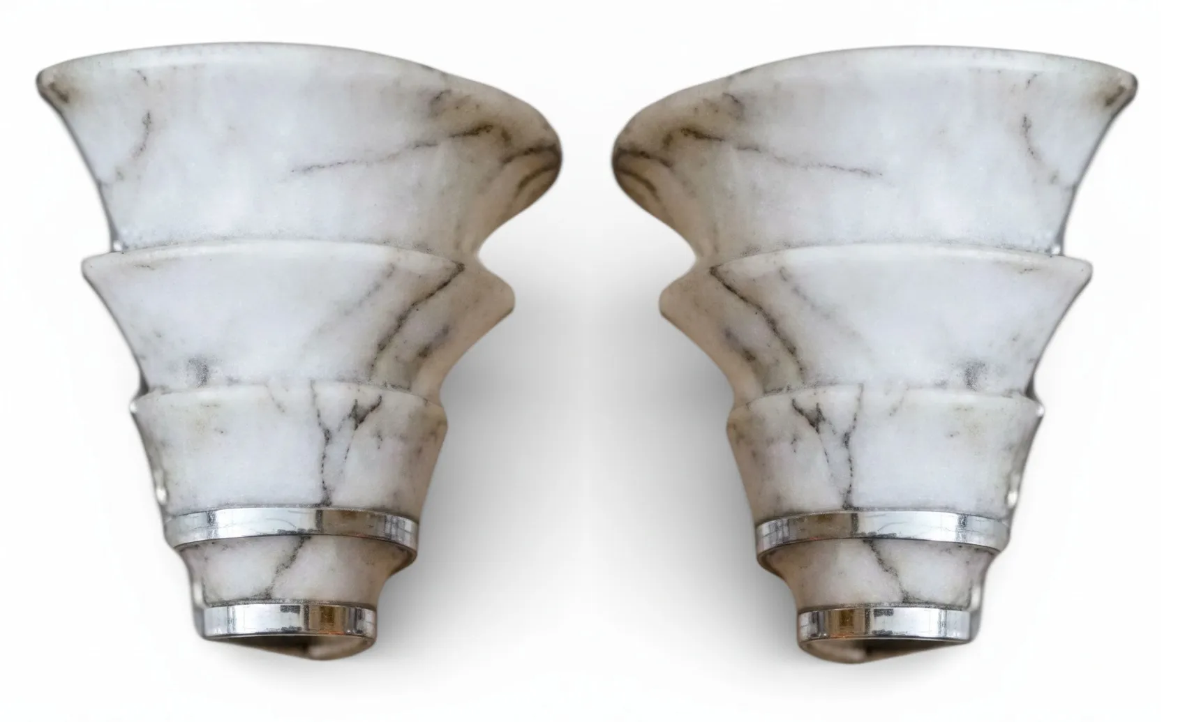 Antique pair of sconces featuring layered design and metallic accents, decorative lighting.