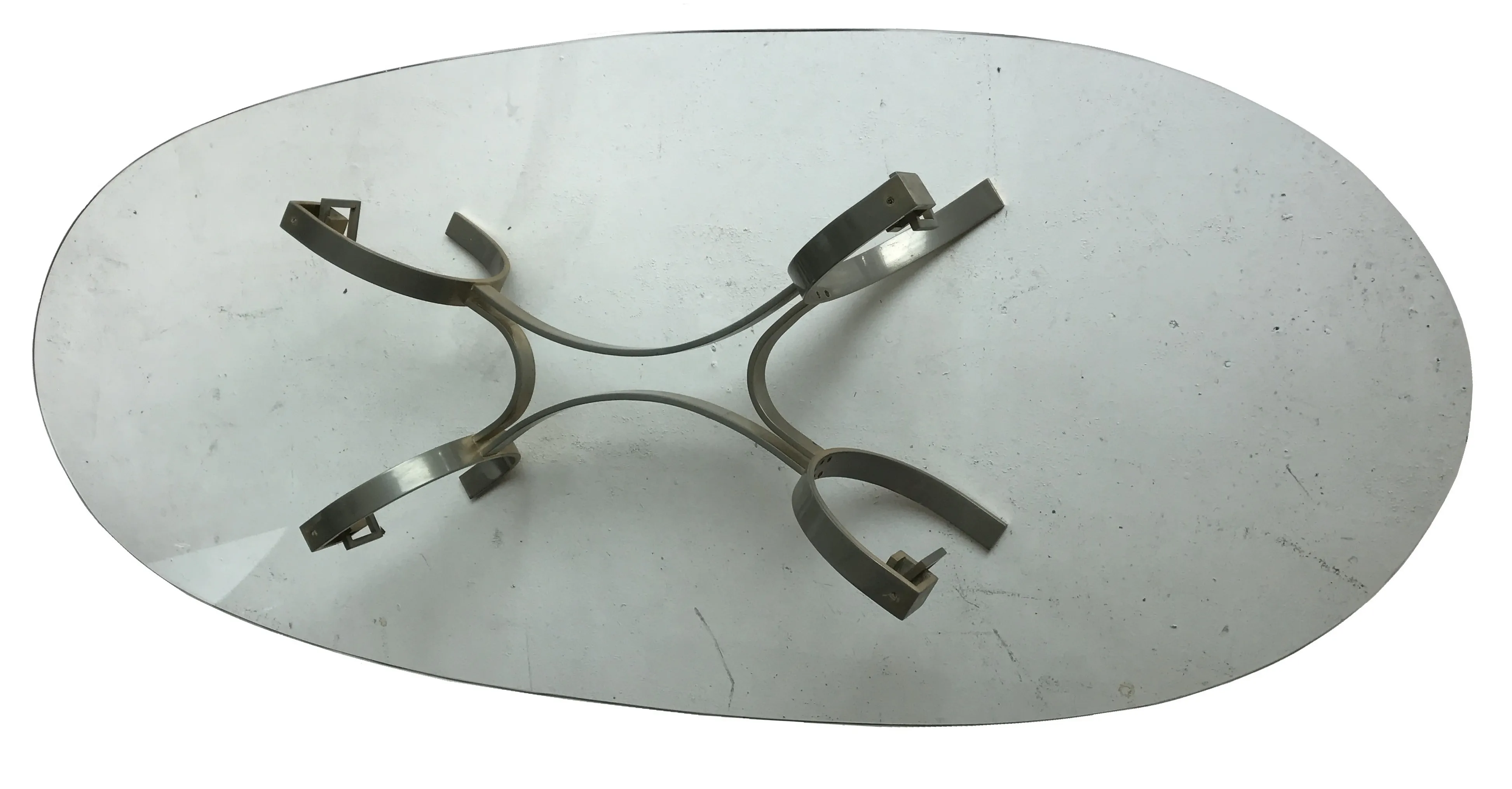 antique oval coffee table with metal base in neutral setting
