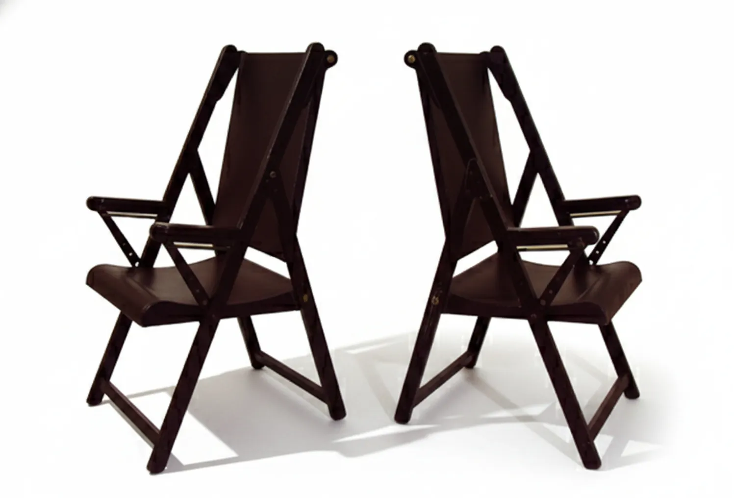 two antique armchairs with arms, awaiting restoration