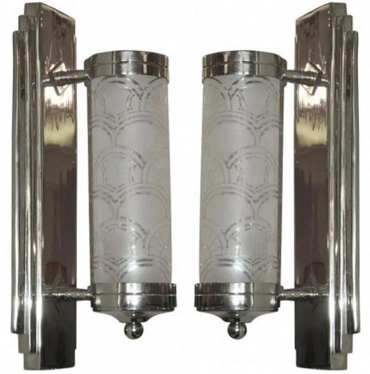 Antique pair of sconces featuring decorated white glass cylinders, providing soft, elegant light suitable for any setting.