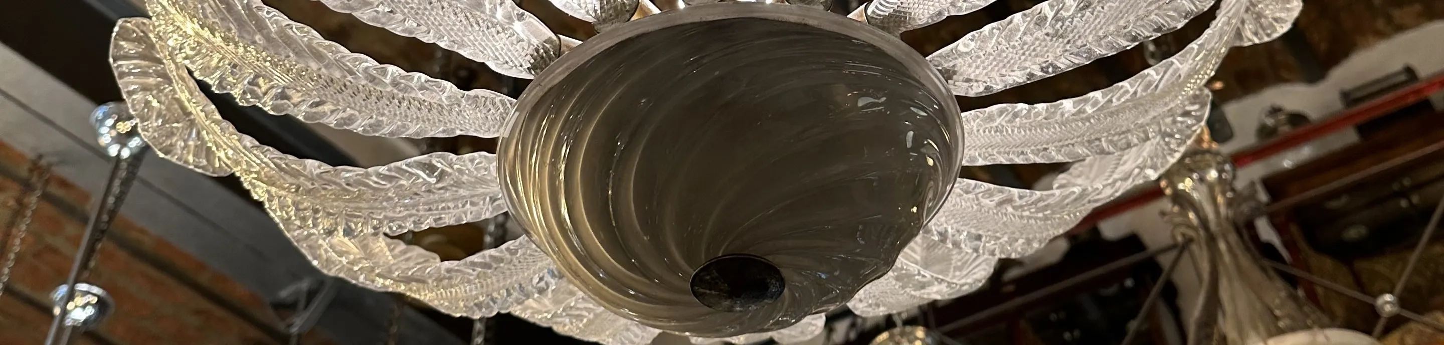 Antique glass chandelier in art nouveau style with ornate details, cozy ambiance.