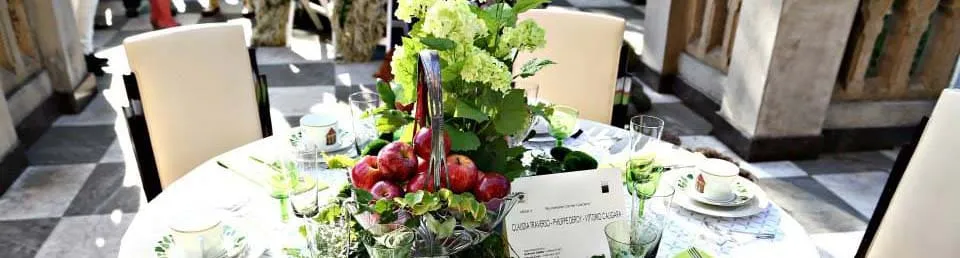 Table decorated with fruits and flowers in an elegant setting