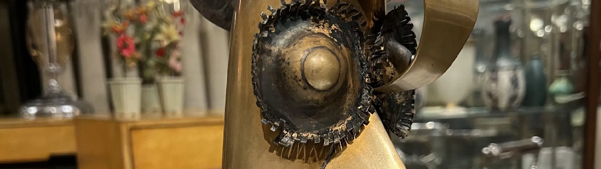 Unique abstract metal sculpture with fluid shapes, set in a vintage environment.