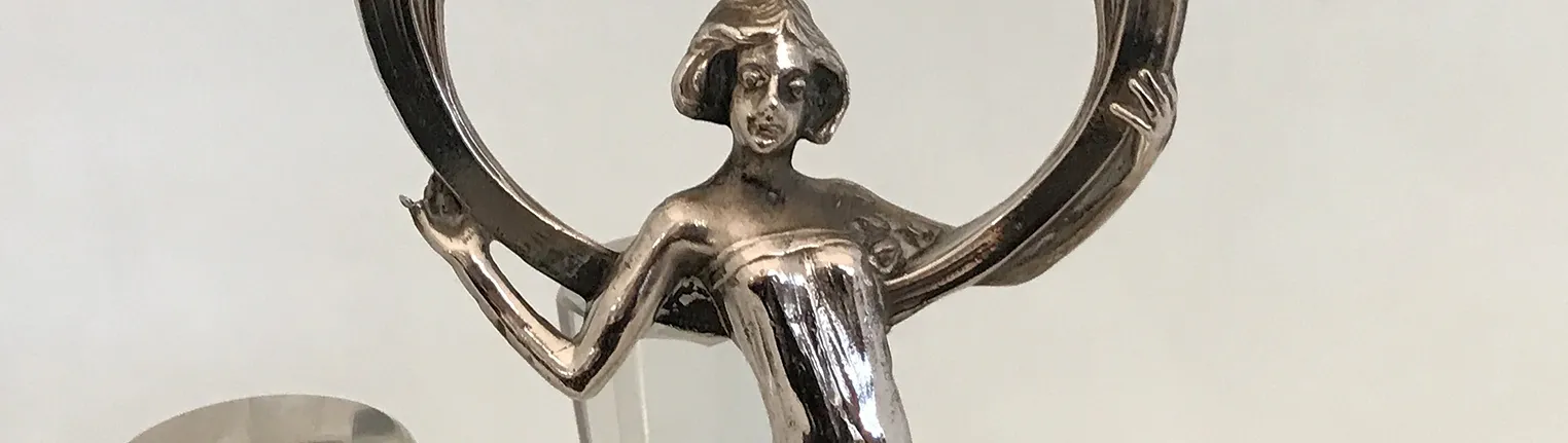 Art Nouveau female figure with a large halo, decorative detailing.