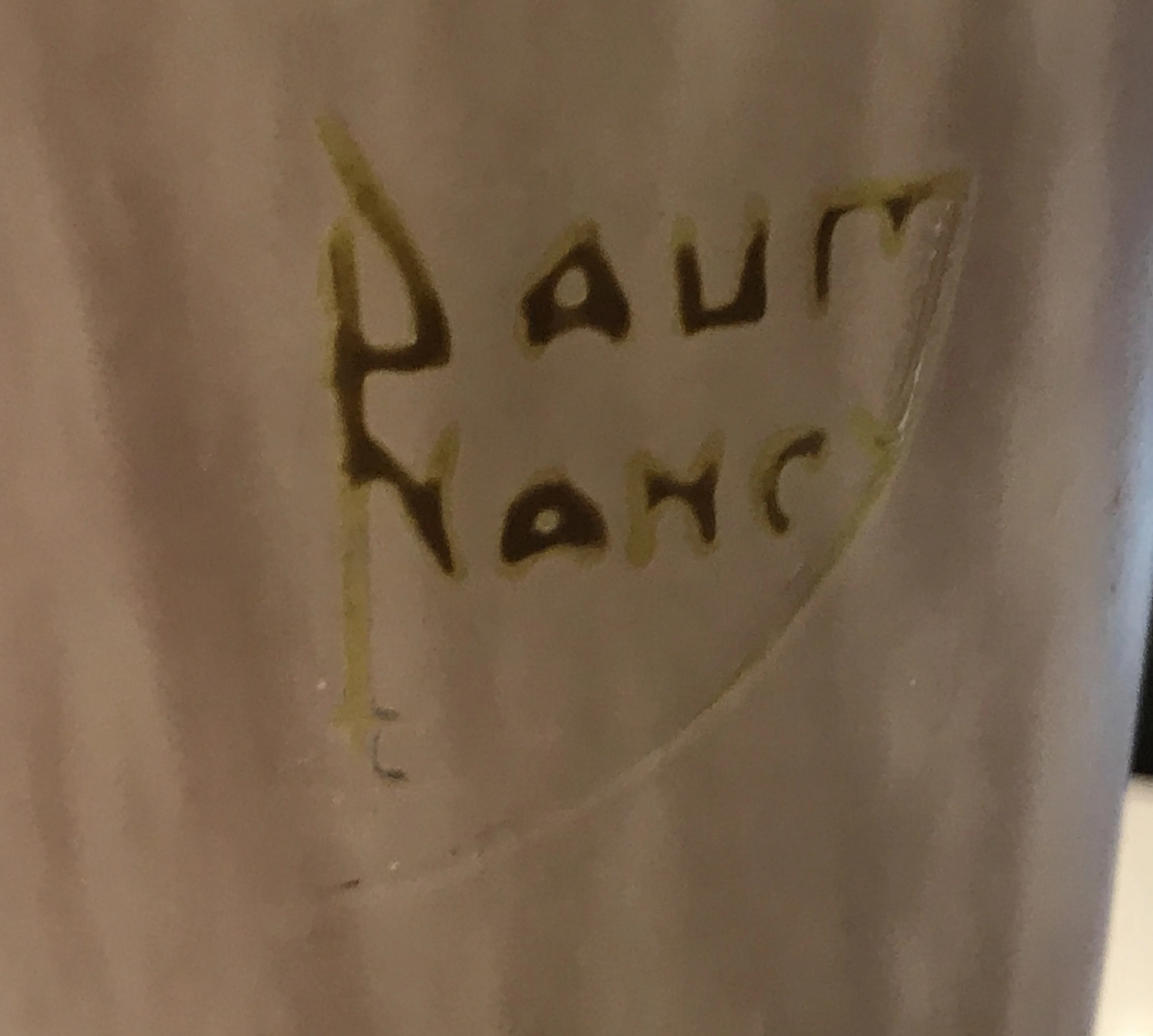 Close-up of an antique Daum Nancy seal with inscription.