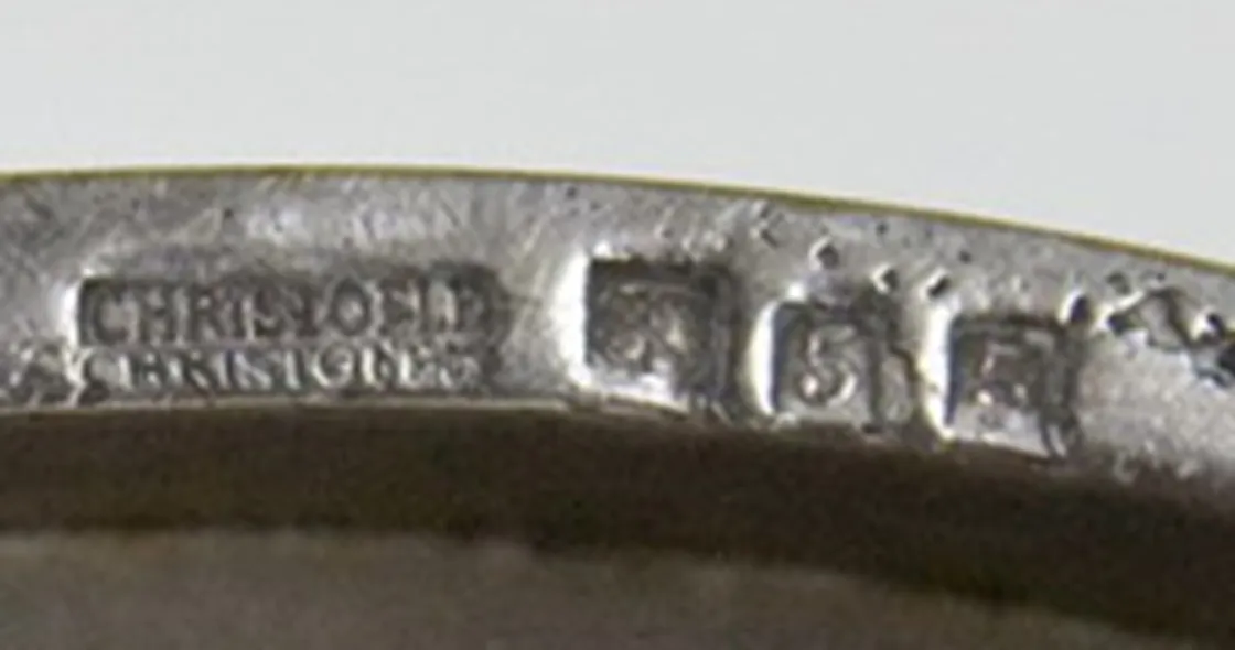 antique seal Christofle with visible details, surrounded by antiques.