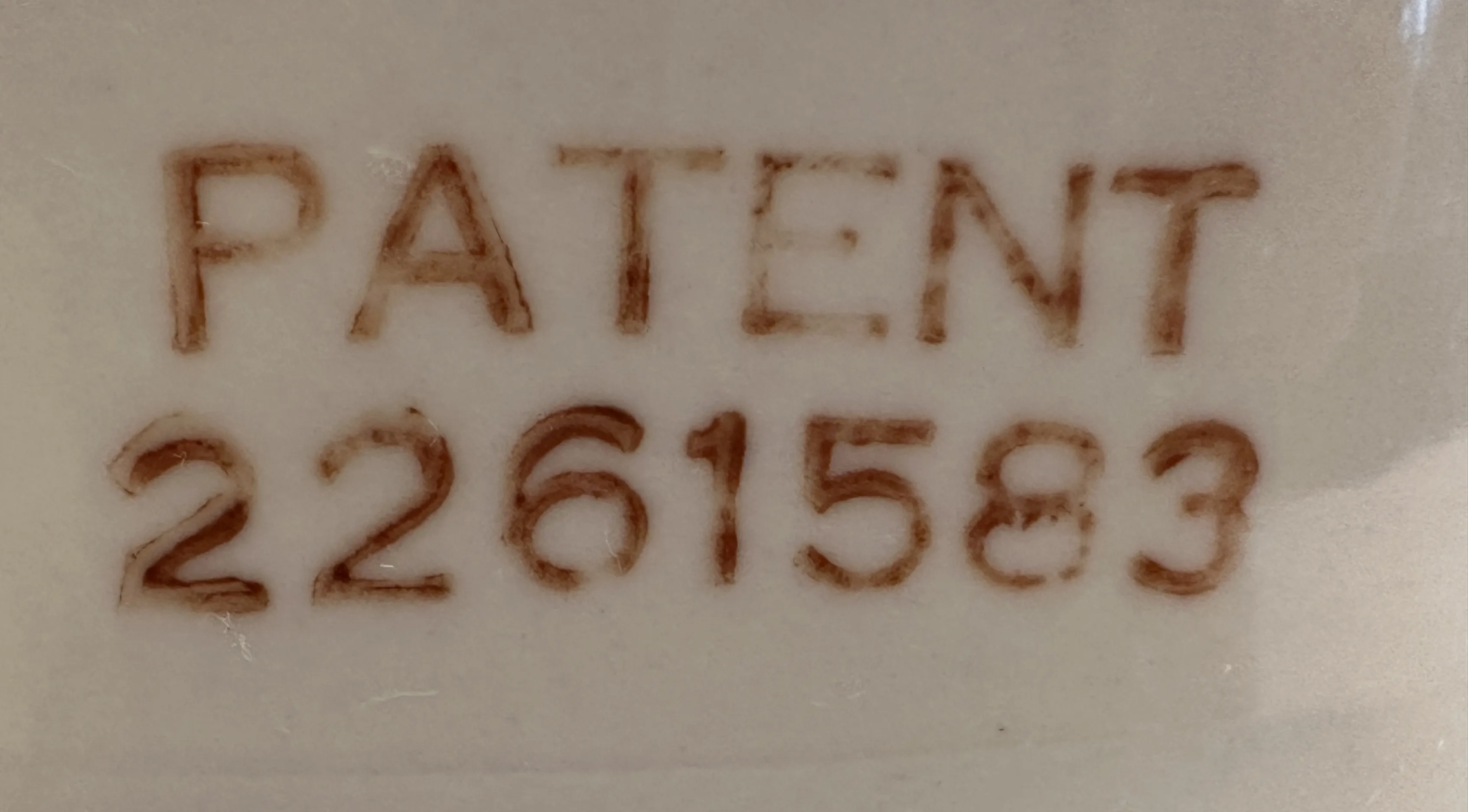 antique seal featuring patent number 2261583 embossed
