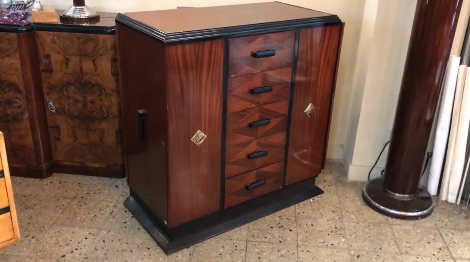 Antique cabinet with five drawers and decorative accents