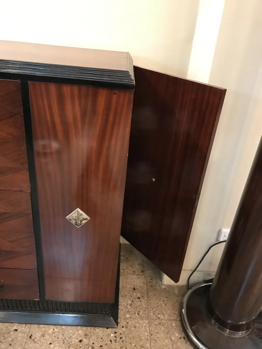 Commode ancienne en bois avec détail décoratif, cadre élégant.