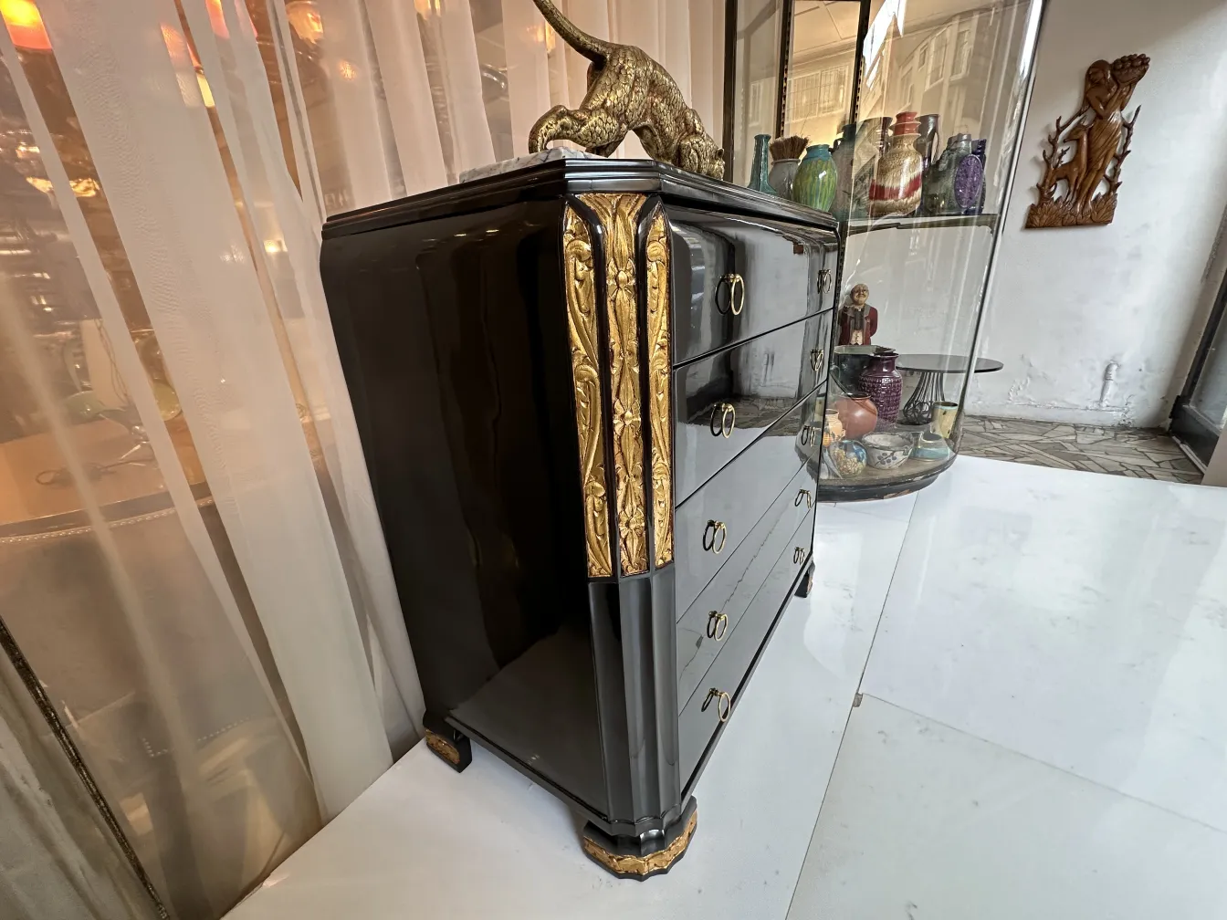 Cómoda antigua con detalles dorados, decorada y elegante.