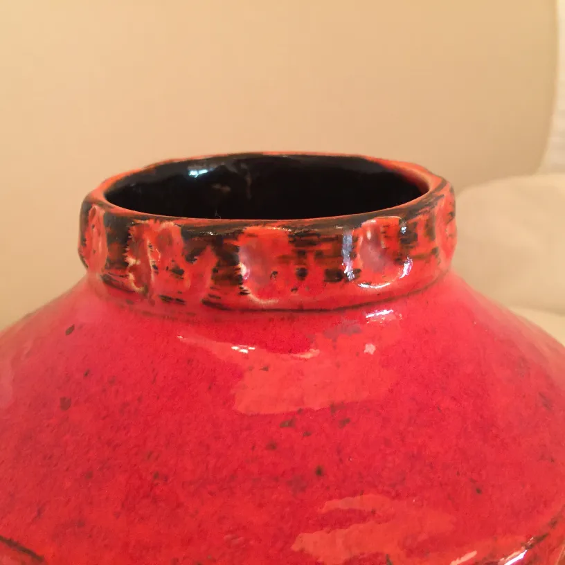 red ceramic vase with carved decoration