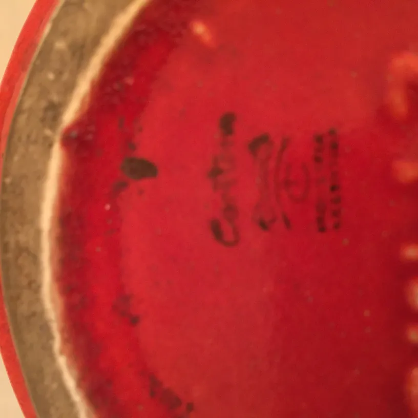 Antique red ceramic with distinctive decorations.