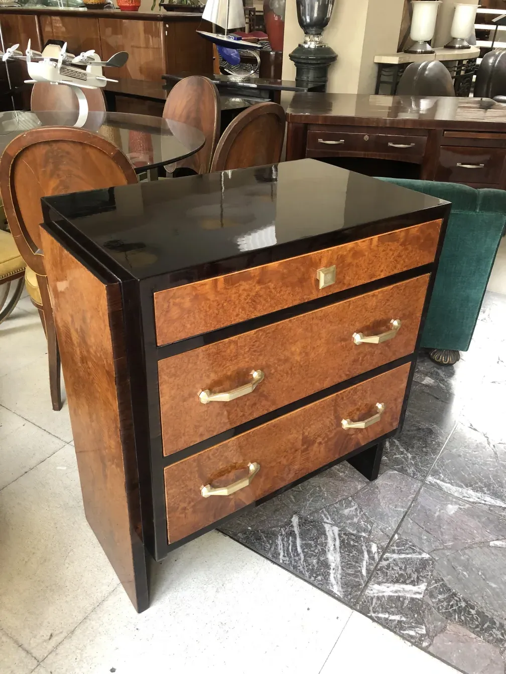 Antique wooden cabinet with golden handles in an elegant setting.