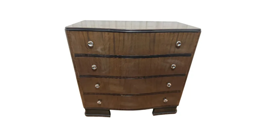 Antique cabinet featuring four drawers and decorative elements.