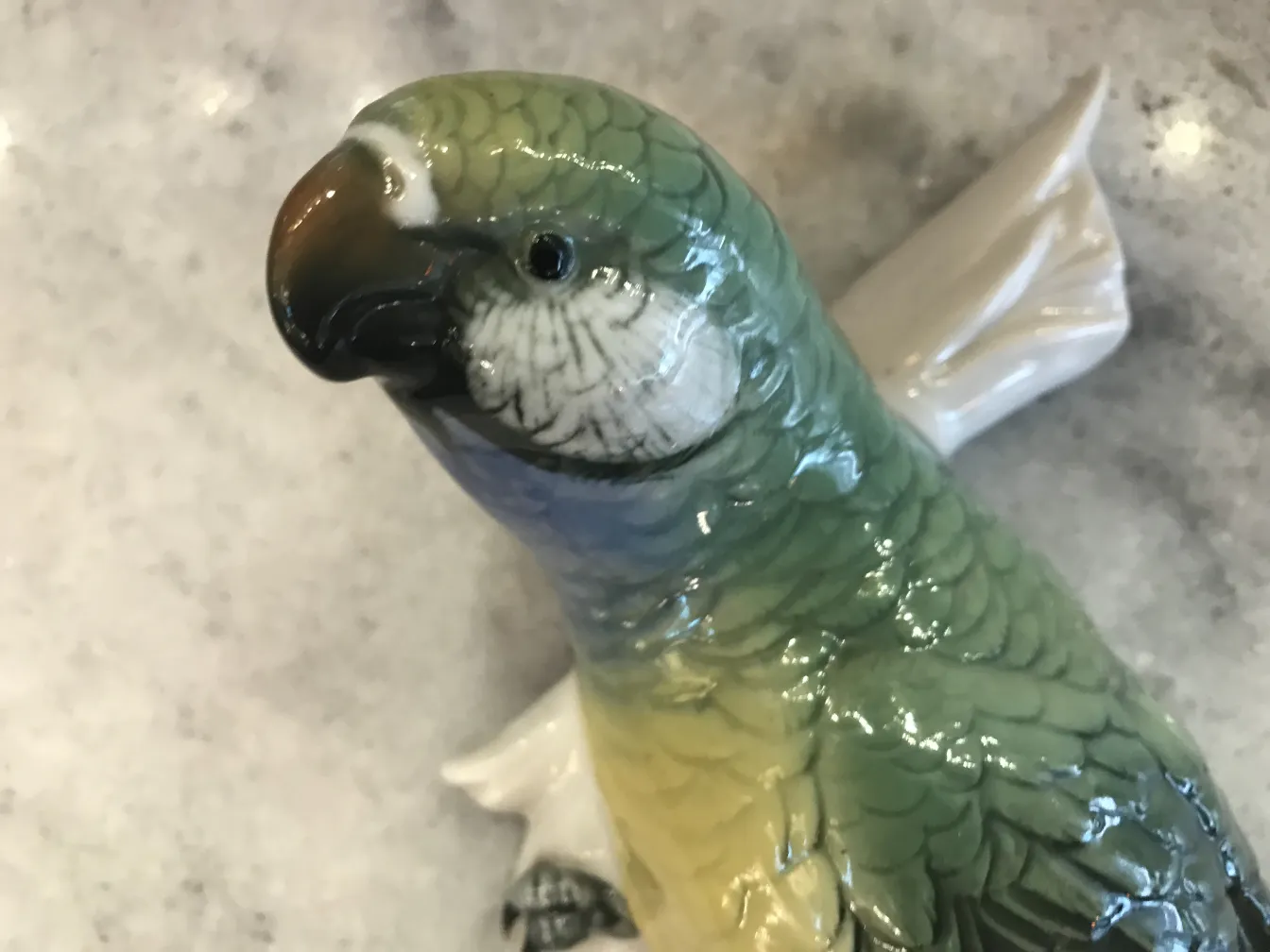Antique ceramic sculpture of a green parrot-shaped bird