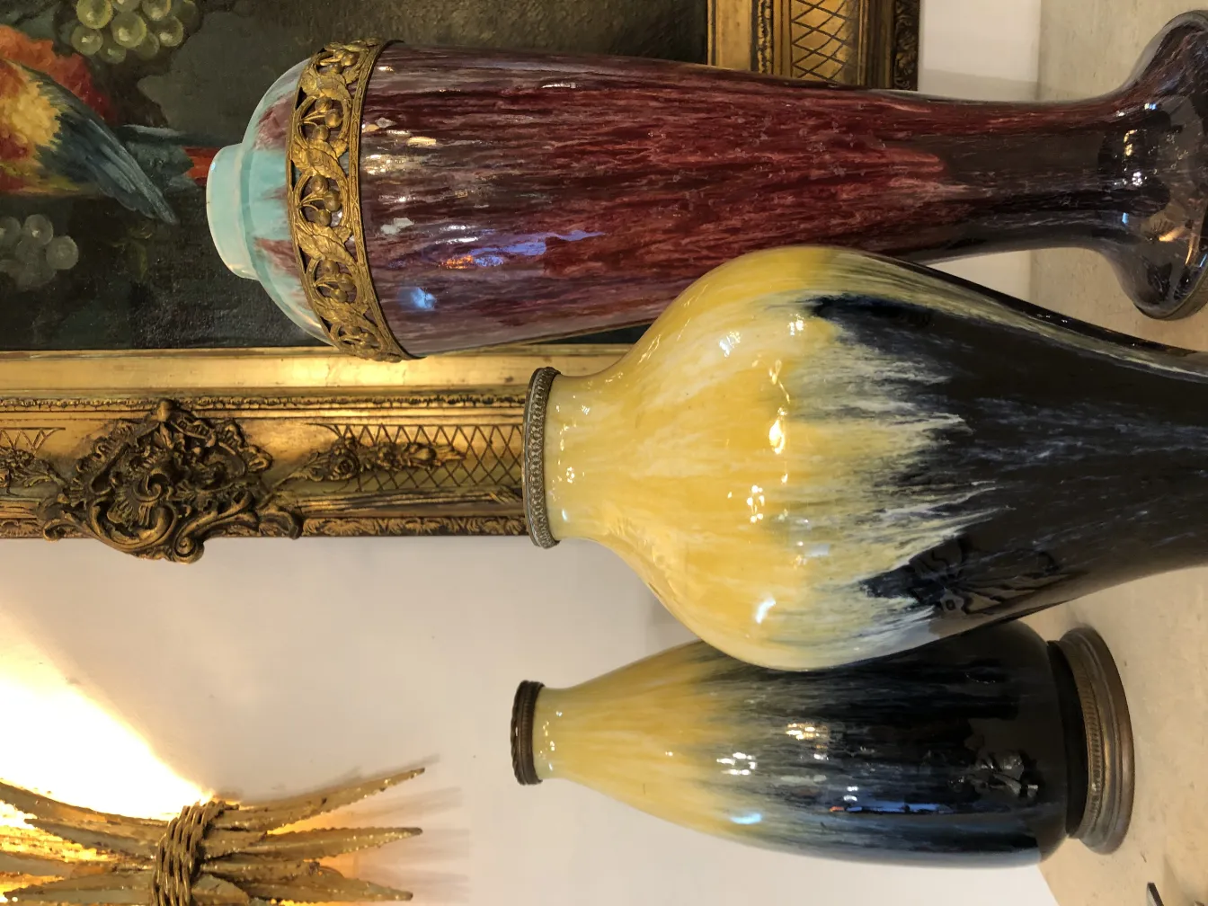 Three antique ceramic vases in vibrant colors.