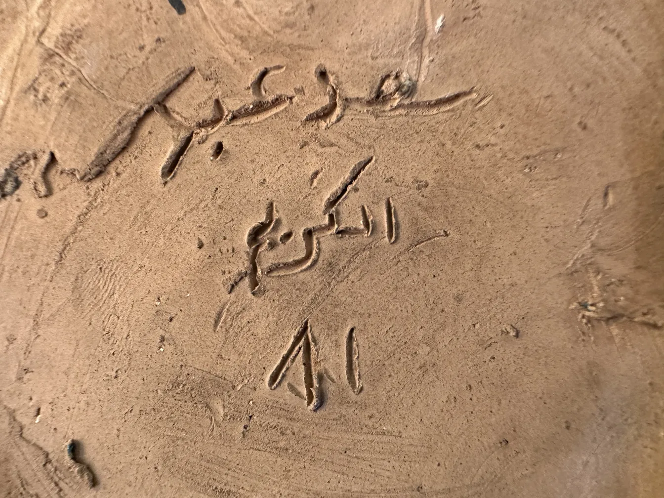 고대 도자기에 새겨진 글씨와 장식적 세부 사항.