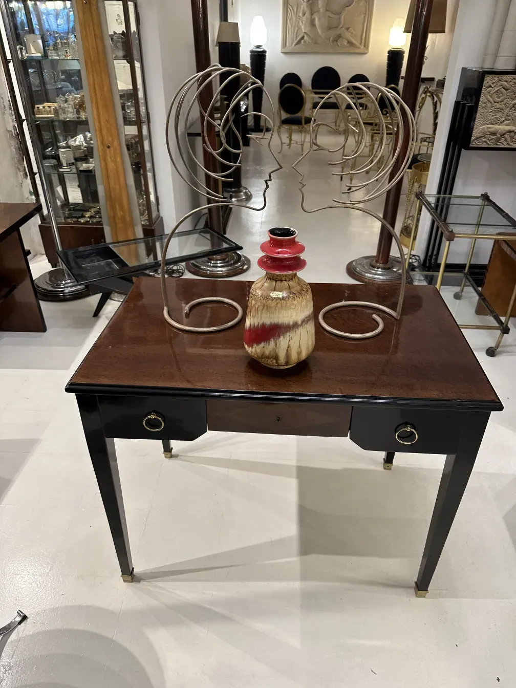 Antique ceramic vase by Carstens Tönnieshof with red and beige details on elegant table.
