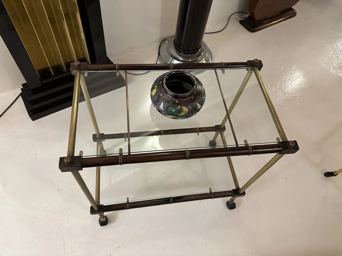 Antique decorative ceramic on glass table, featuring colorful design.