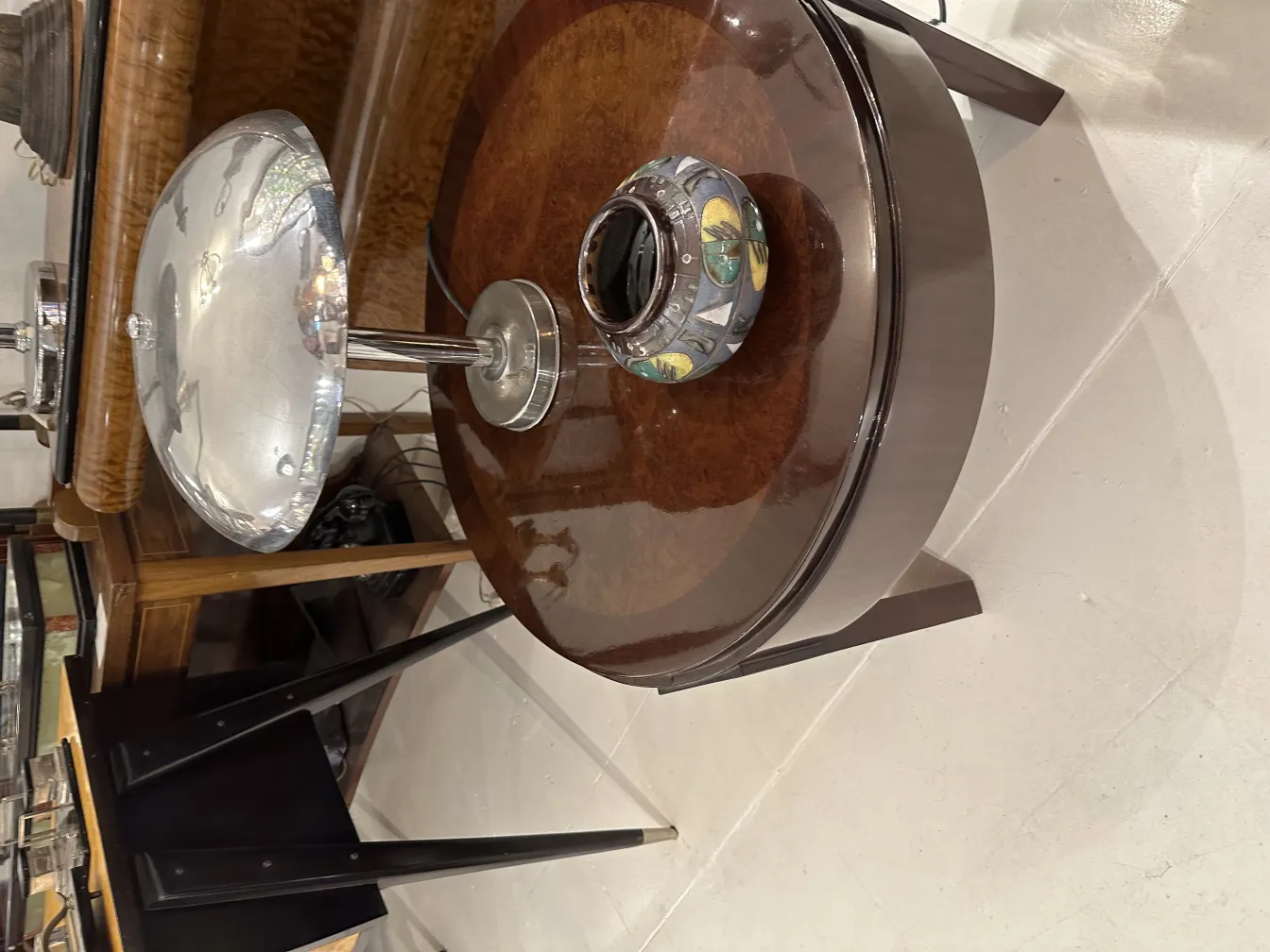 silver lamp on a table with decorative ceramic