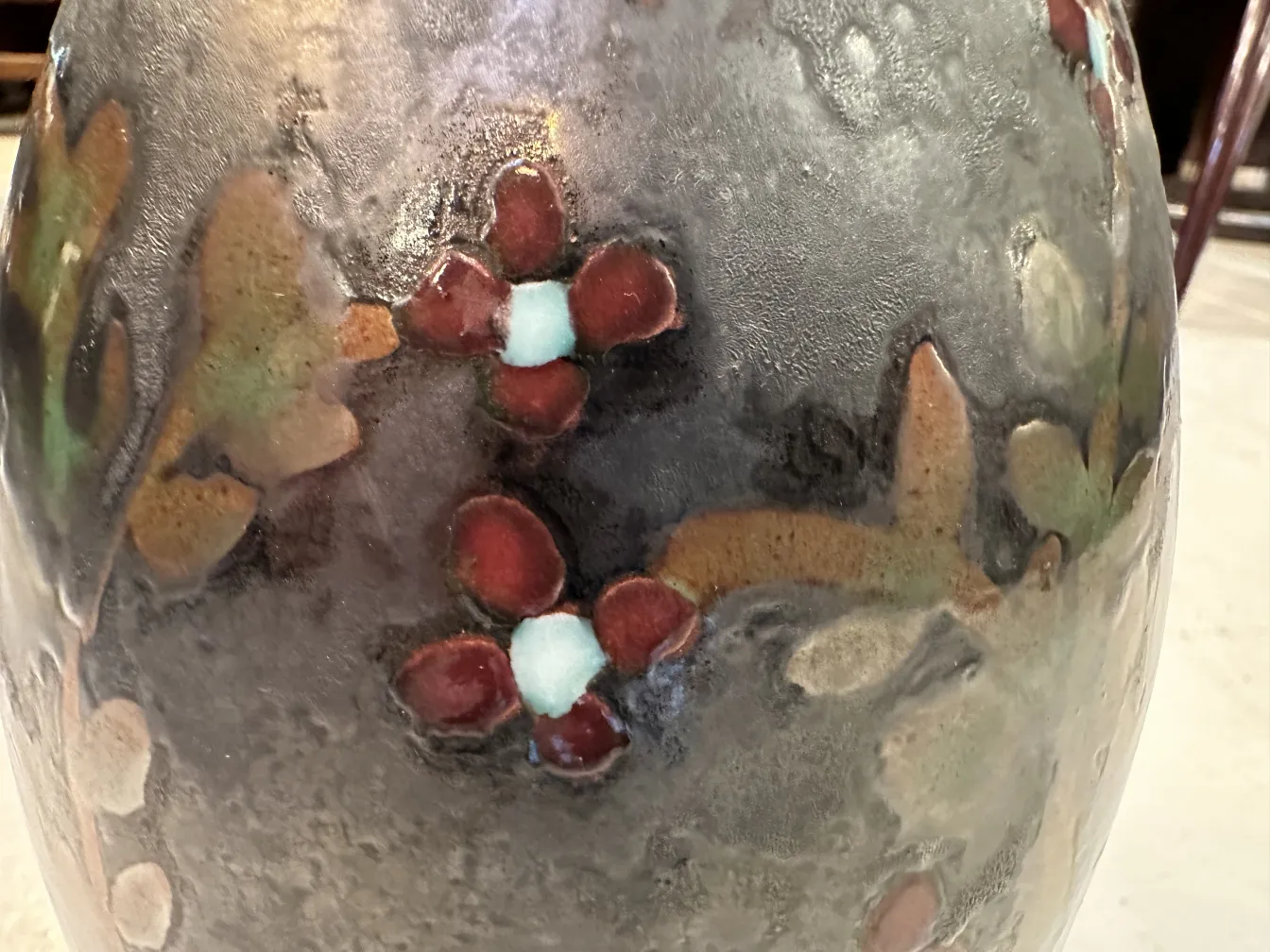 Vaso de cerâmica antiga com padrões florais coloridos