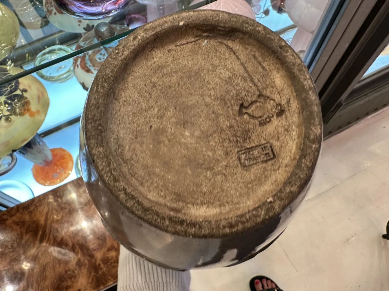 Base of an antique ceramic item by Bourguet with visible details.