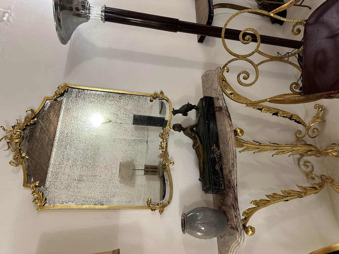 Decorative antique ceramic vase on a table with a mirror