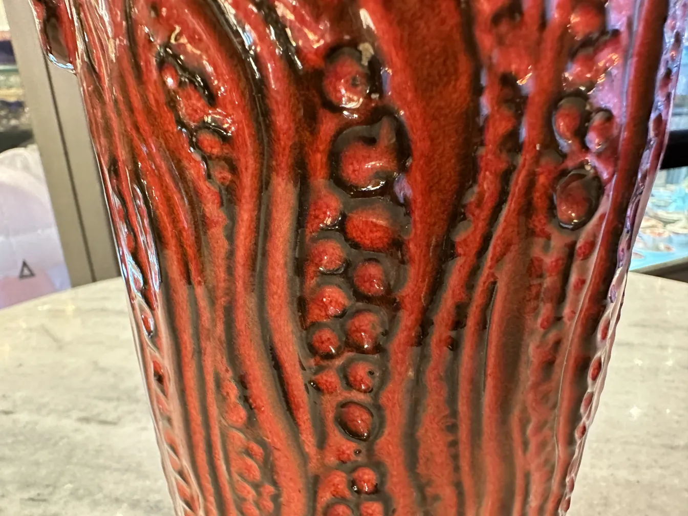 Antique ceramic vase with red and black texture