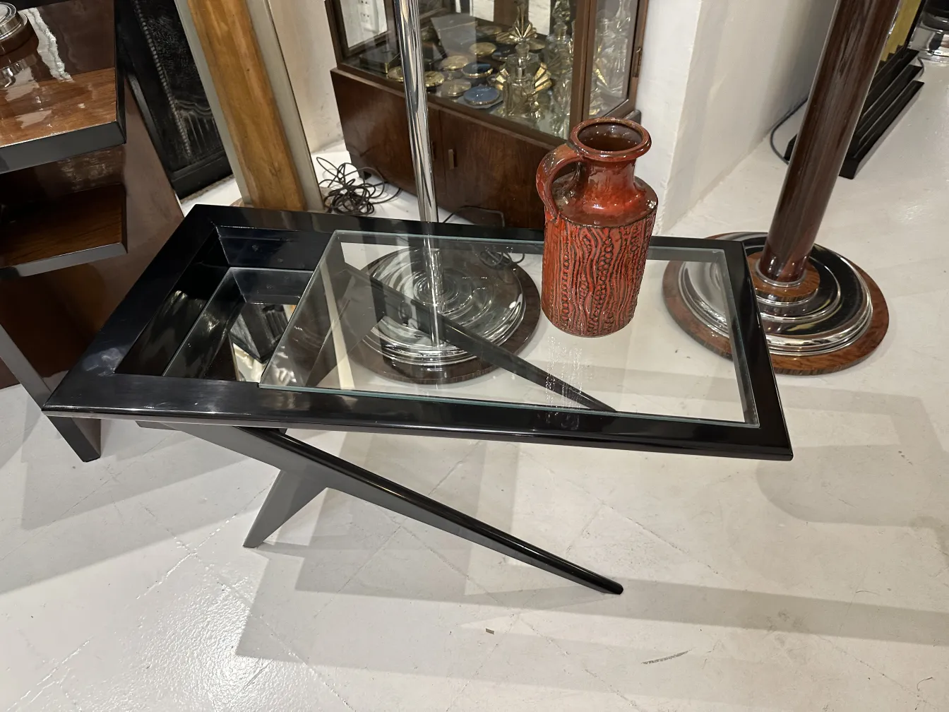 Antique ceramic vase with decorative design on a modern table.
