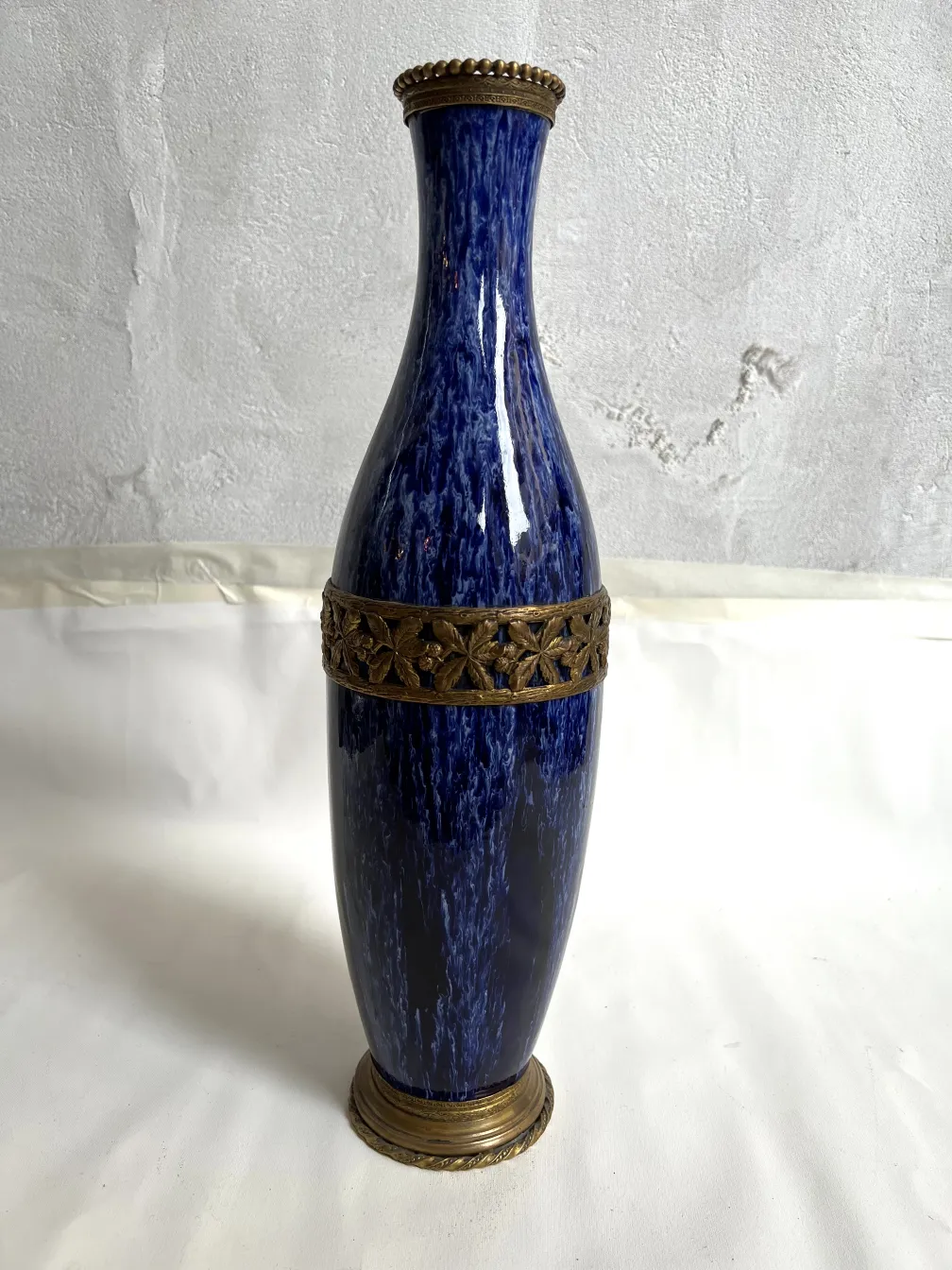 Antique blue ceramic vase with gold details.