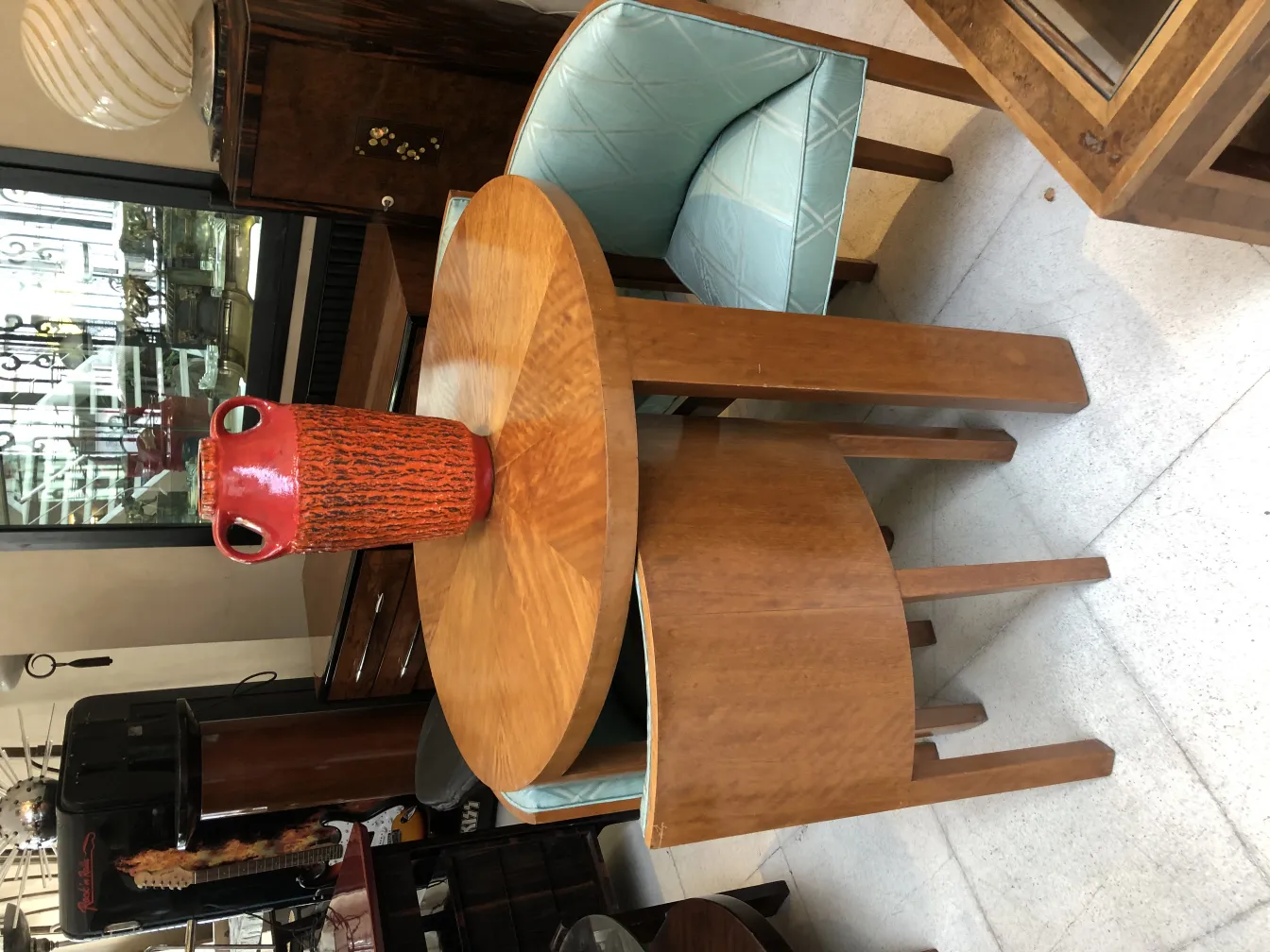 Antique red ceramic vase on a wooden table.