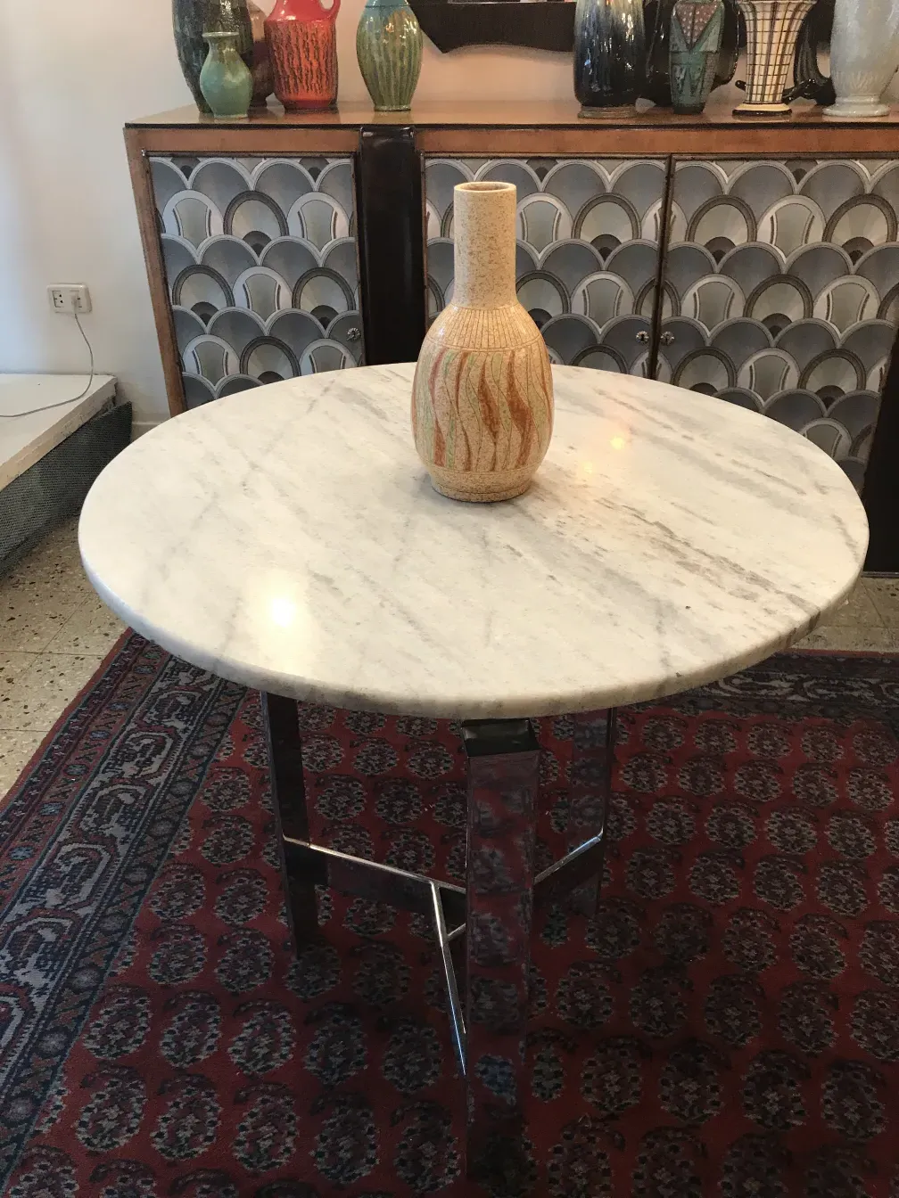 ز vase قديم بسيراميك ذو تصميم زخرفي على طاولة.