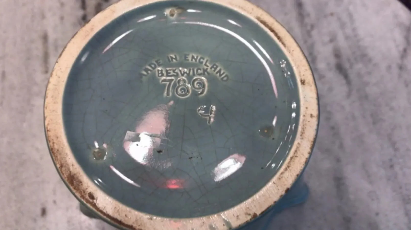 Antique Beswick ceramic base with light blue color and visible markings.